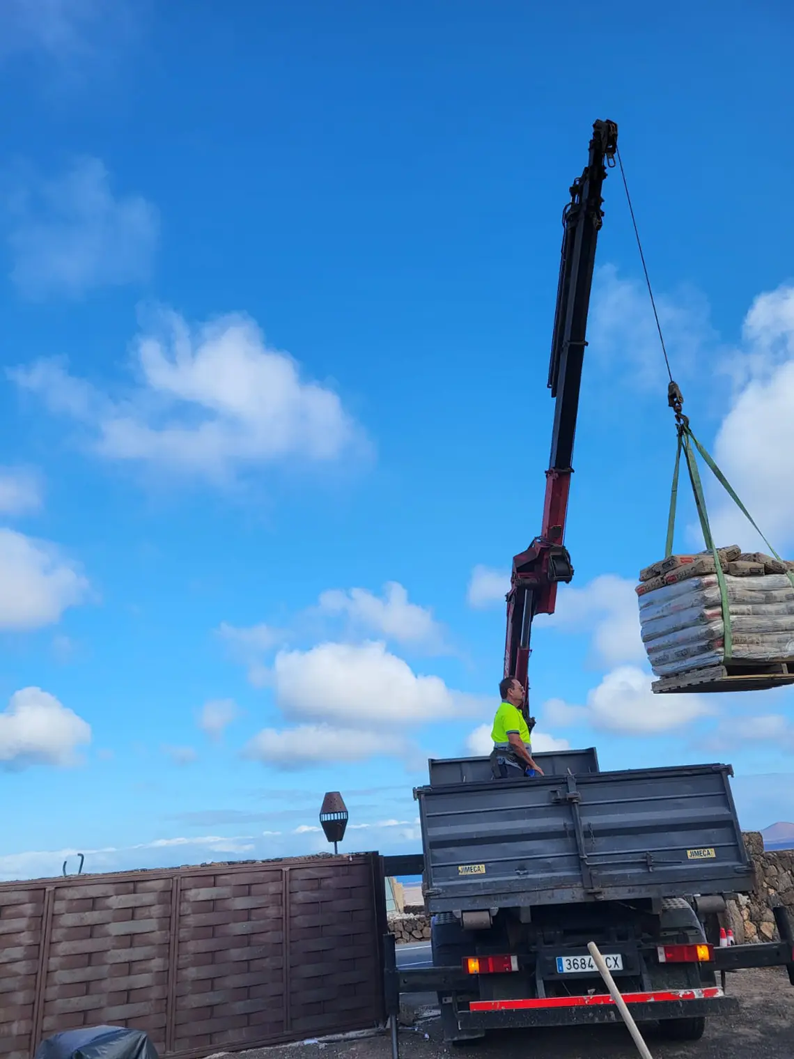 Grçua transportando sacos de cemento para la casa piloto